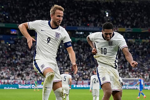 Harry Kane celebrates with Jude Bellingham after scoring England's second goal